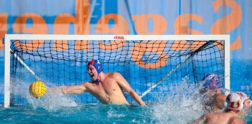 Water polo goalkeeper blocks shot